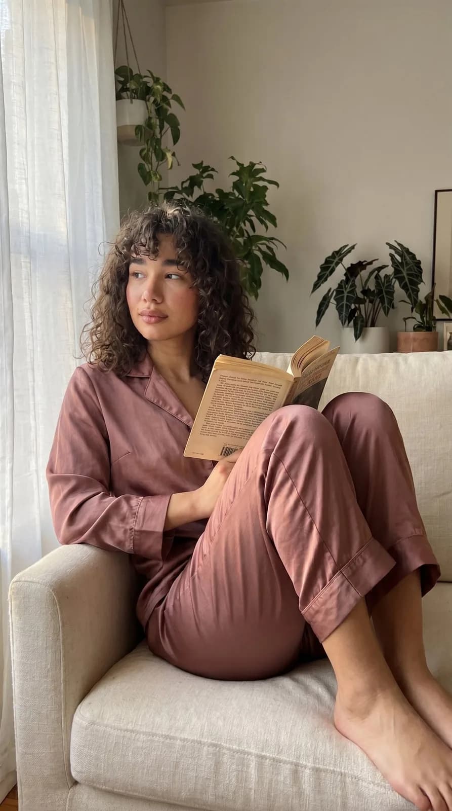 The same face, a book in the armchair